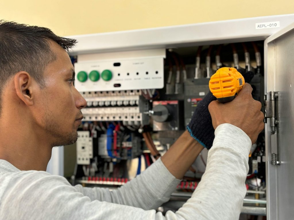 man working on an electrical panel
