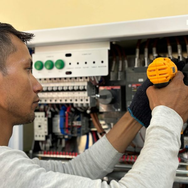 man working on an electrical panel